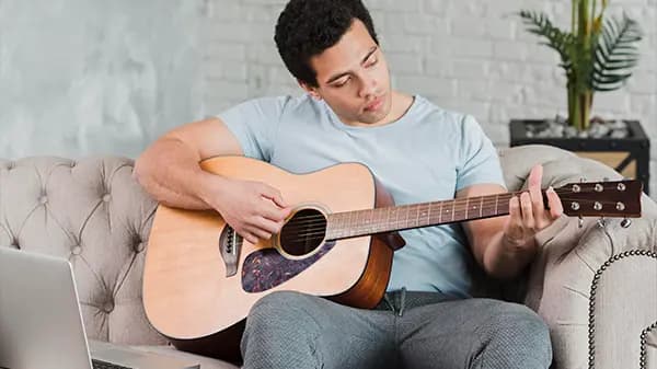 Boy learning guitar online