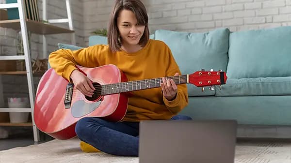 Girl playing guitar in class